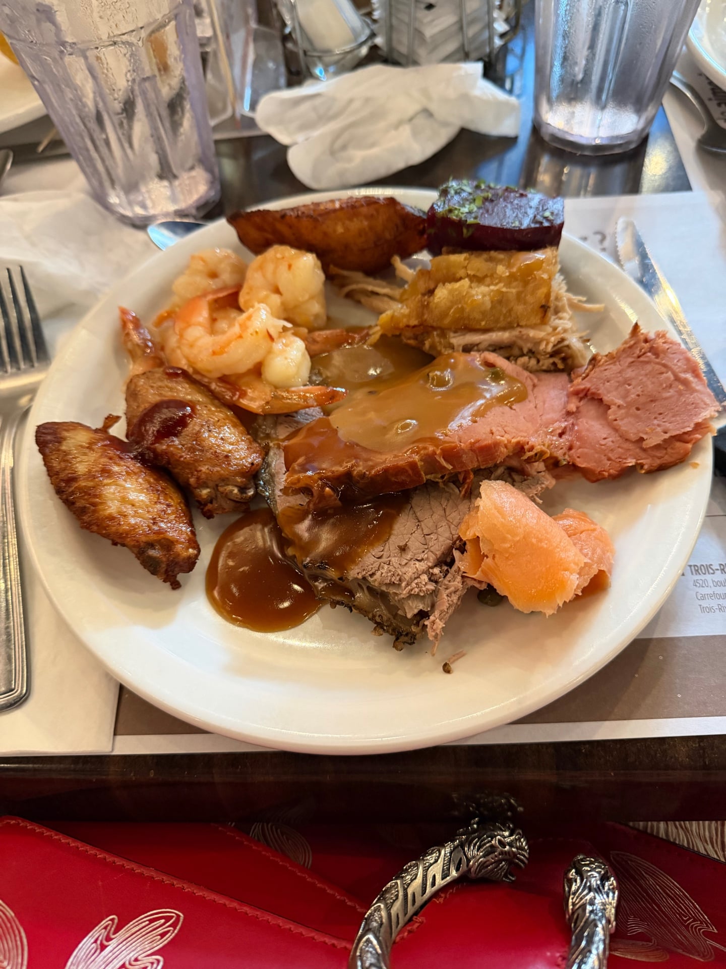 Buffet plate with smoked meat, roast pork, shrimp, and other selections