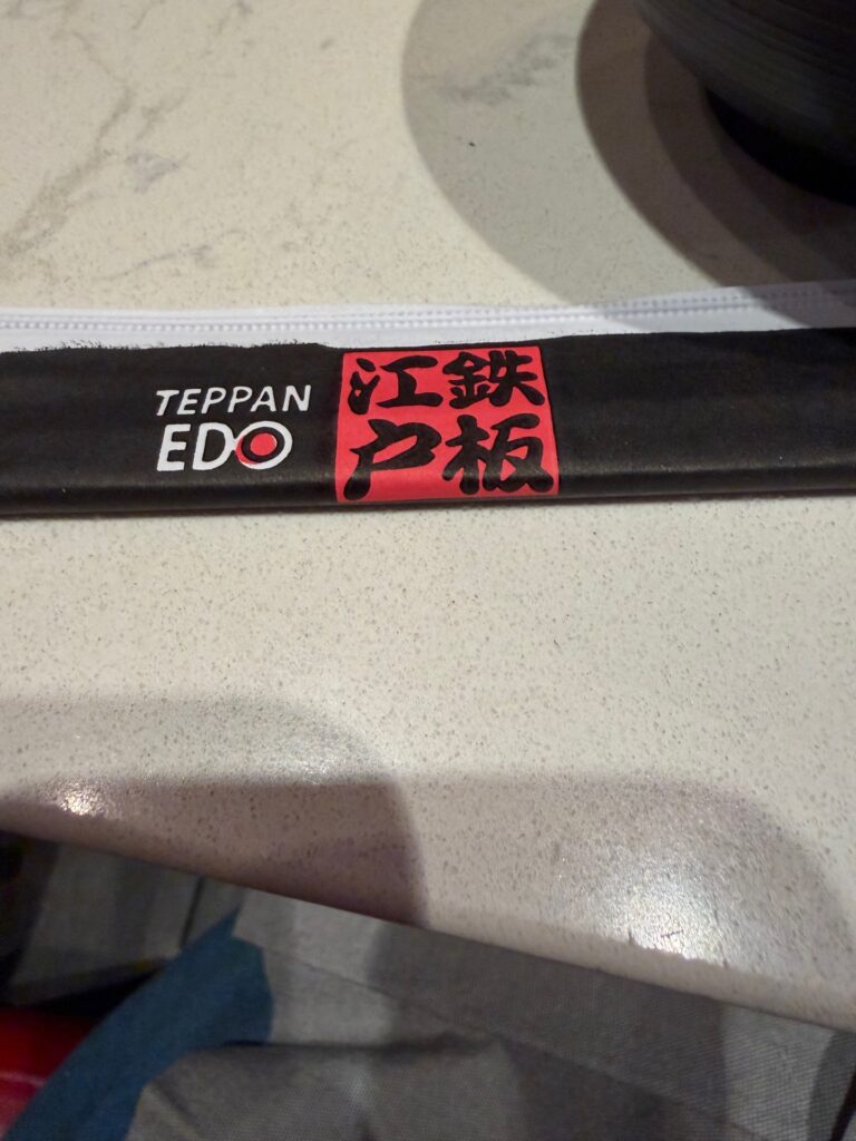 Teppan Edo branded utensil sleeve on a dining table
